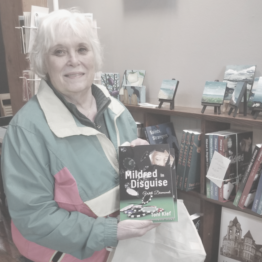 Author Toni Kief holding her book, Mildred in Disquise